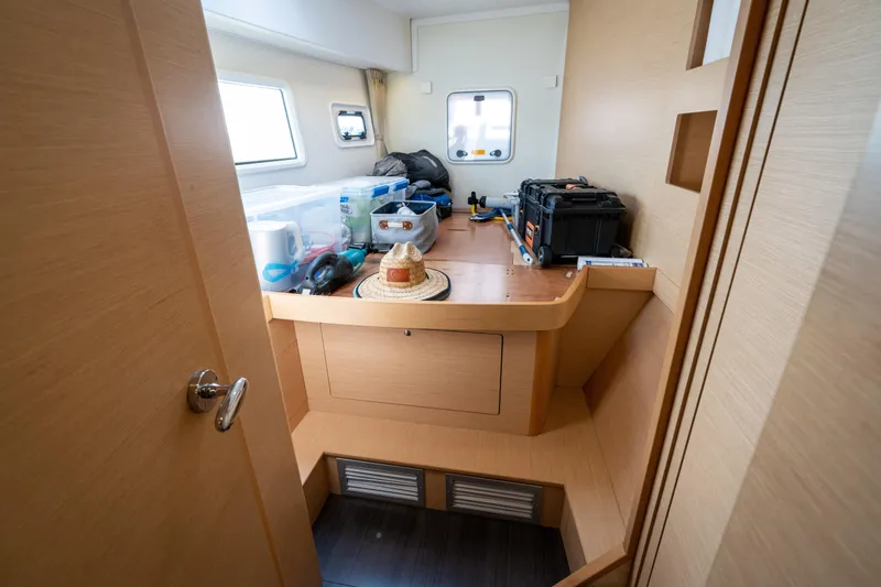 Slide: The Image of Interior of a 2017 Lagoon 42 with wood paneling and storage space. - 47