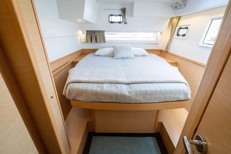 Slide: The Image of The image shows a cozy cabin with a double bed, surrounded by wood paneling and windows. - 43