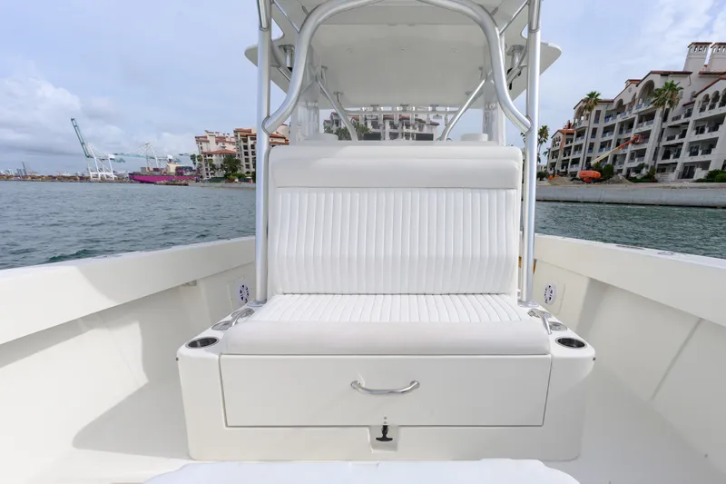 Slide: The Image of 2011 SeaVee 340B Open boat with white seating, dockside view, and waterfront buildings. - 4