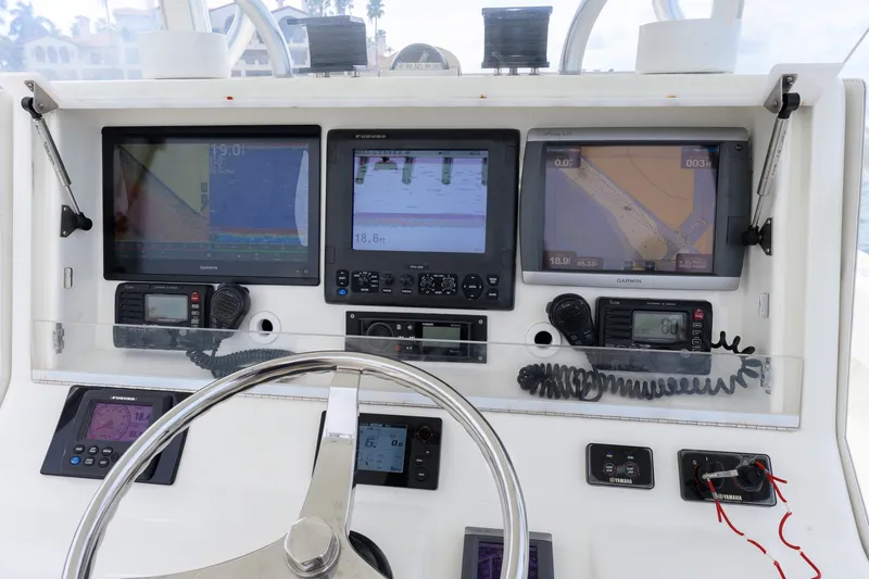 Slide: The Image of Control panel of a 2011 SeaVee 340B Open boat with navigation screens and instruments. - 6
