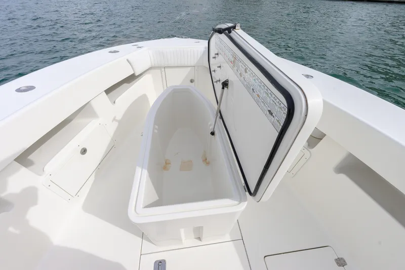 Slide: The Image of 2011 SeaVee 340B Open boat with open storage compartment, docked on calm water. - 3