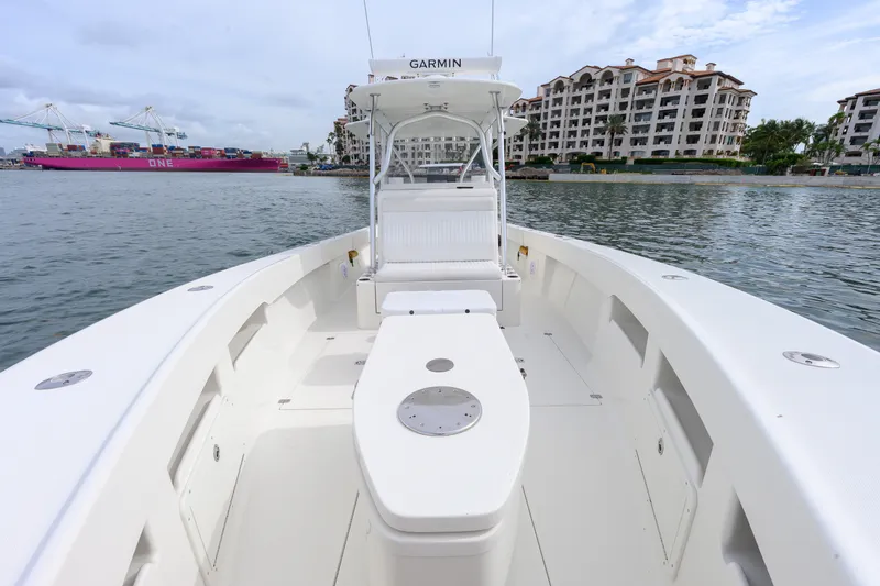 Slide: The Image of 2011 SeaVee 340B Open boat on water, with cityscape and cargo ship in background. - 19