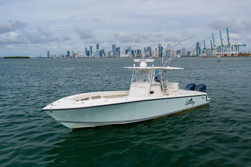 The Image of 2011 SeaVee 340B Open boat on water with city skyline in background. - 1