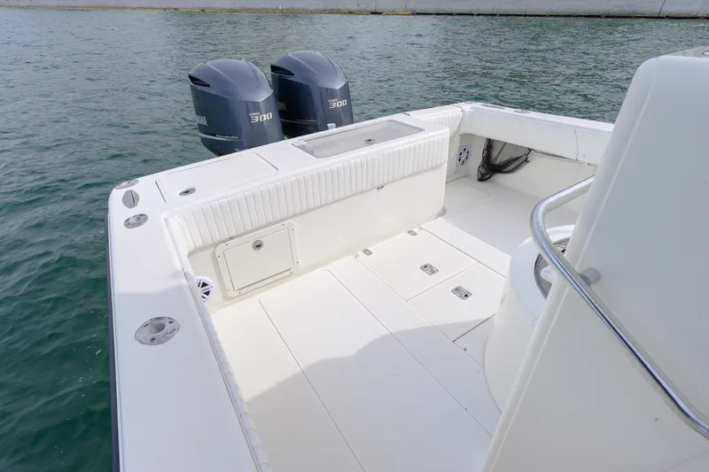 Slide: The Image of 2011 SeaVee 340B Open boat deck with twin Yamaha 300 engines on calm water. - 5