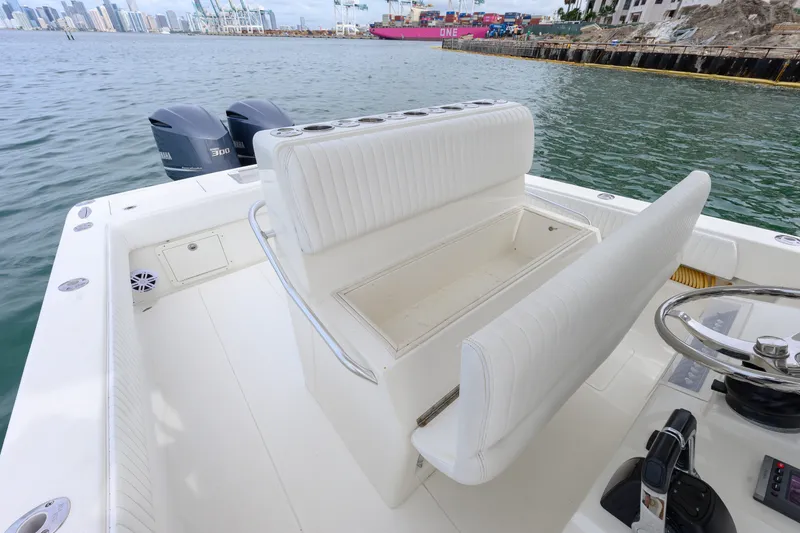 Slide: The Image of 2011 SeaVee 340B Open boat interior with dual Yamaha engines, docked near city skyline. - 20