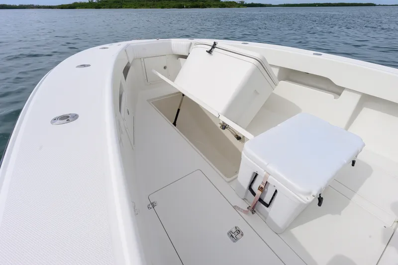 Slide: The Image of 2011 SeaVee 340B Open boat interior with storage compartments and seating, on calm water. - 14