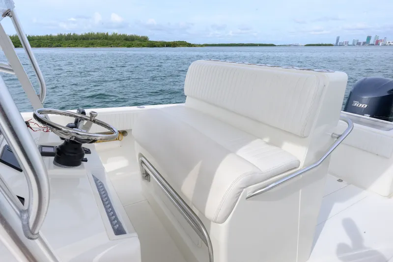 Slide: The Image of 2011 SeaVee 340B Open boat interior with white seating and steering wheel, ocean view. - 9