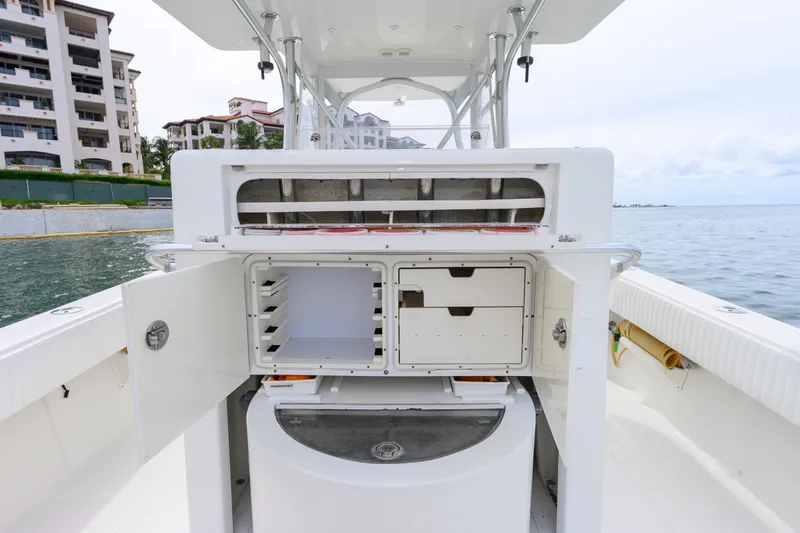 Slide: The Image of 2011 SeaVee 340B Open boat with open storage compartments, docked near waterfront buildings. - 16