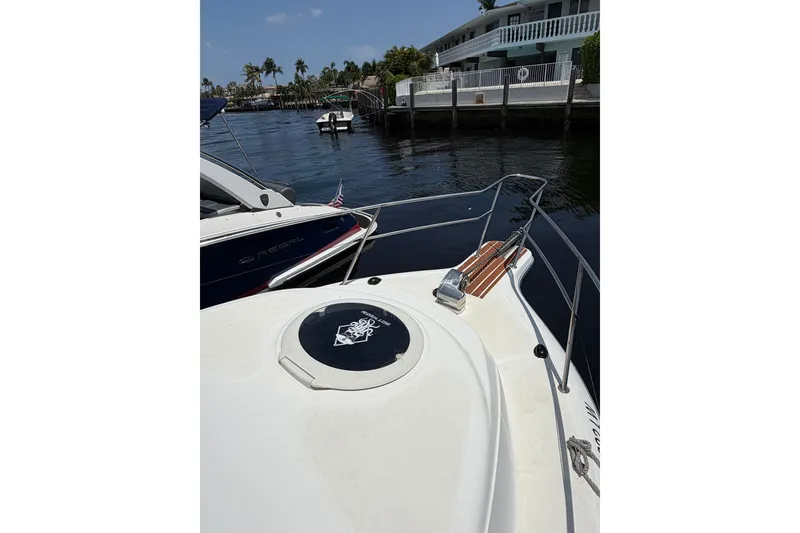 Slide: The Image of 2002 Sea Fox 230 Walk Around boat docked near waterfront homes. - 28