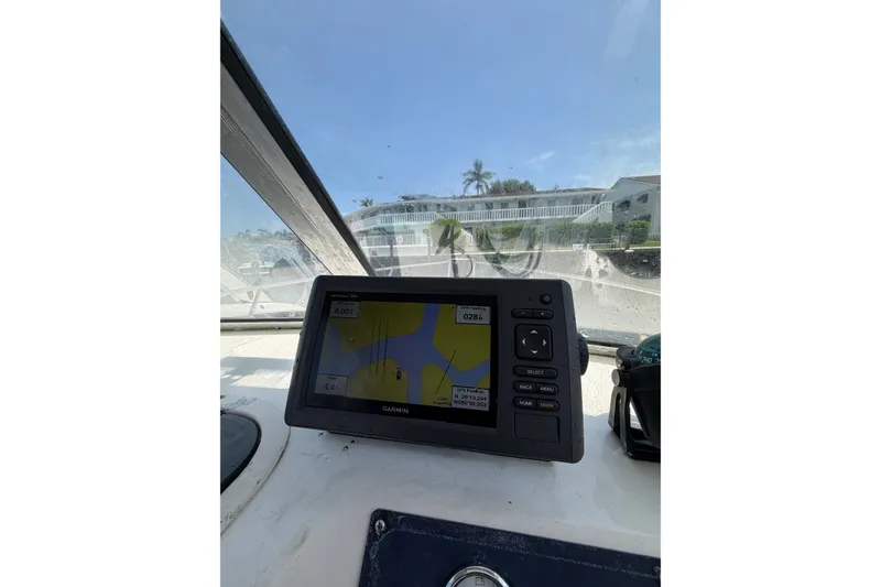 Slide: The Image of Garmin GPS on 2002 Sea Fox 230 Walk Around boat dashboard, sunny day. - 20