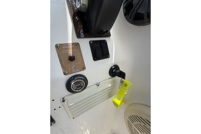 Slide: The Image of Control panel of a 2002 Sea Fox 230 Walk Around boat with key and switches. - 17