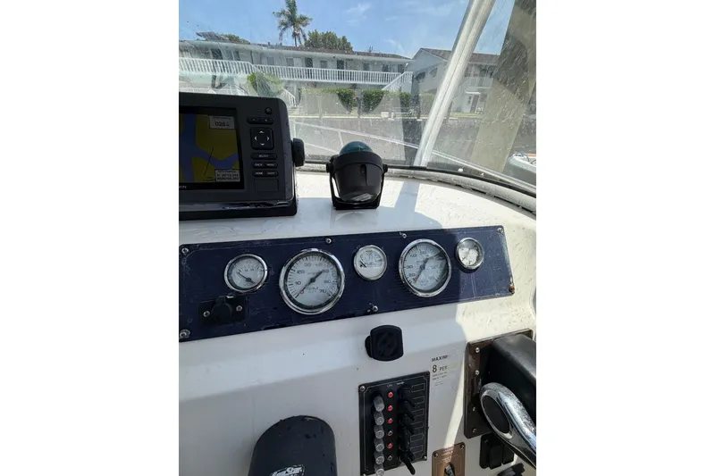 Slide: The Image of Dashboard of a 2002 Sea Fox 230 Walk Around boat with gauges and navigation equipment. - 19