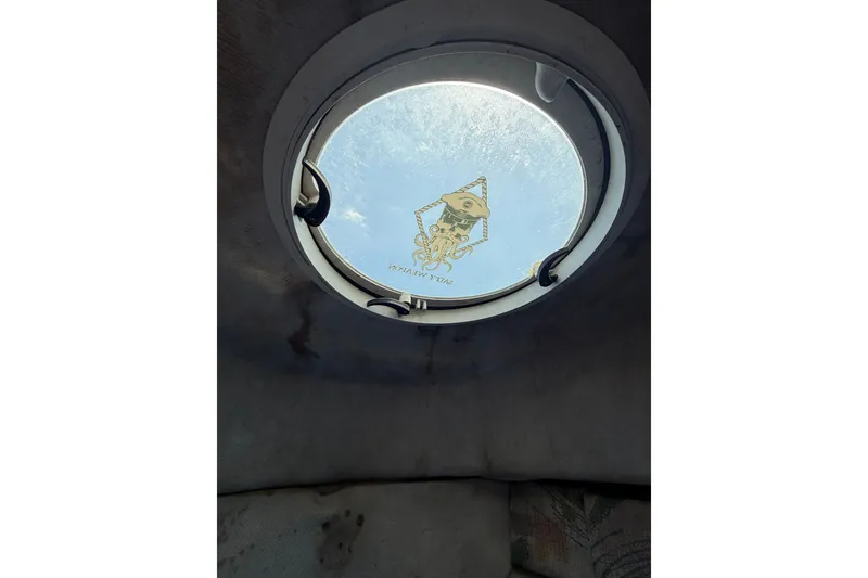 Slide: The Image of Porthole view from 2002 Sea Fox 230 Walk Around boat cabin. - 24