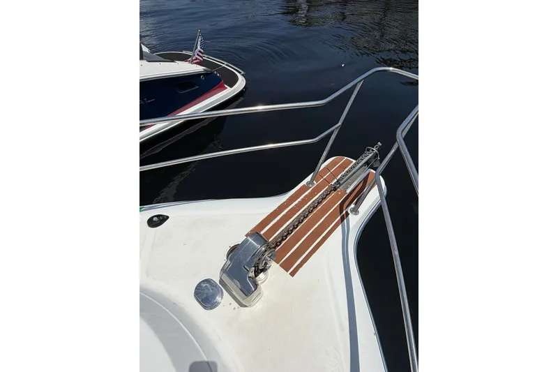 Slide: The Image of Bow of a 2002 Sea Fox 230 Walk Around boat with anchor chain and railing. - 29