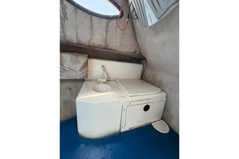 Slide: The Image of 2002 Sea Fox 230 Walk Around cabin interior with sink and storage compartment. - 23