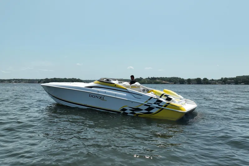Slide: The Image of 2002 Donzi 38 Daytona speedboat on open water, featuring sleek design and vibrant colors. - 6
