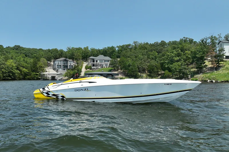 The Image of 2002 Donzi 38 Daytona speedboat on a lake with waterfront homes in the background. - 0