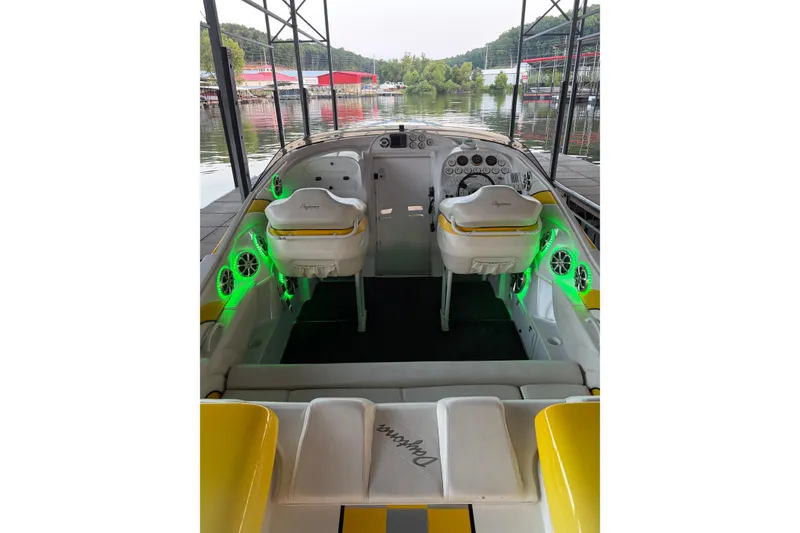 Slide: The Image of 2002 Donzi 38 Daytona boat interior with illuminated green accents and dual captain seats. - 22