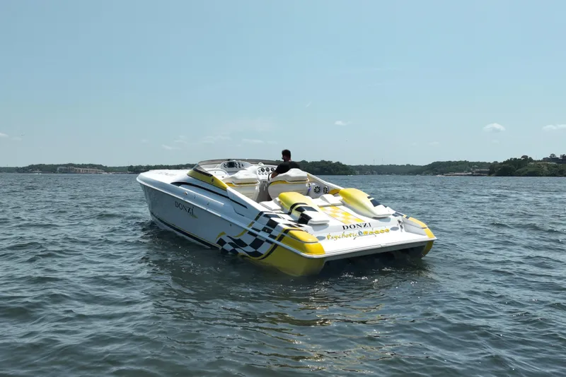 Slide: The Image of 2002 Donzi 38 Daytona speedboat on open water, featuring vibrant yellow accents. - 5