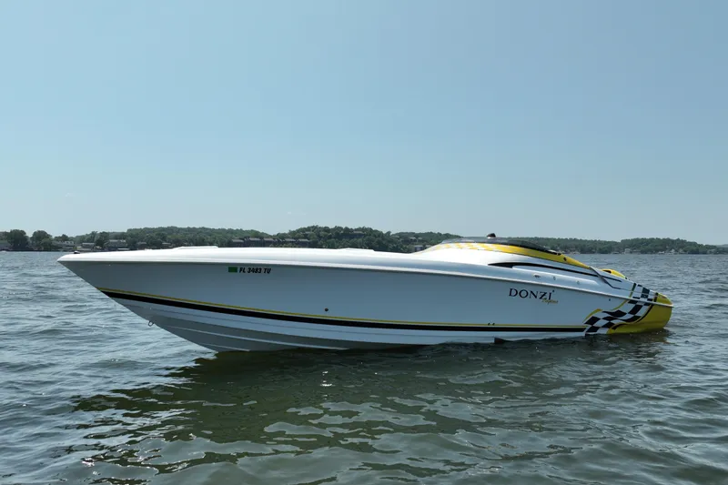 Slide: The Image of 2002 Donzi 38 Daytona speedboat on calm water, showcasing sleek design and vibrant colors. - 8