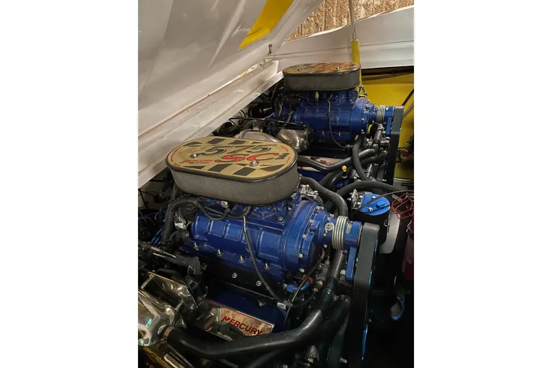 Slide: The Image of Twin Mercury engines in a 2002 Donzi 38 Daytona boat, showcasing powerful performance. - 12