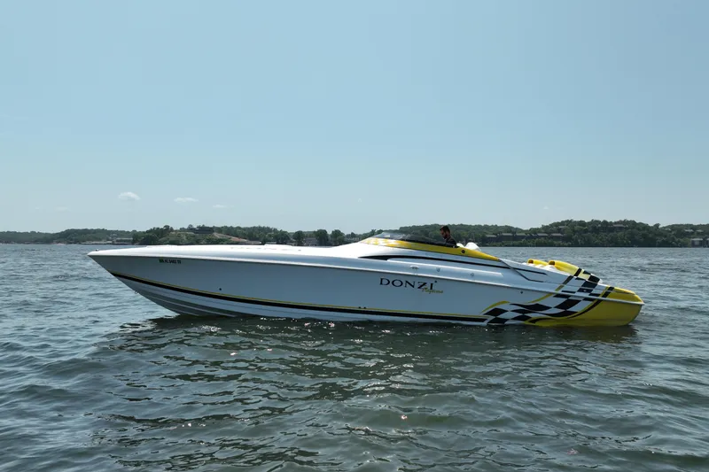 Slide: The Image of 2002 Donzi 38 Daytona speedboat on calm water, featuring sleek design and vibrant colors. - 7