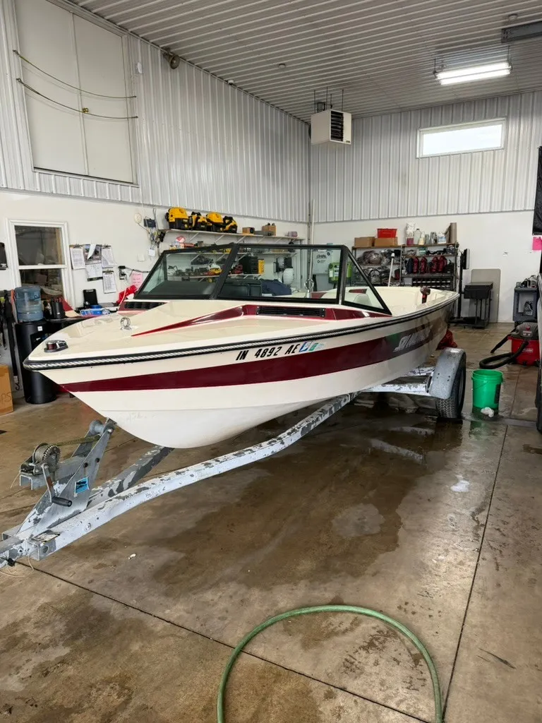 Slide: The Image of A 1987 Correct Craft Ski Nautique 2001 on a trailer in a garage. - 20