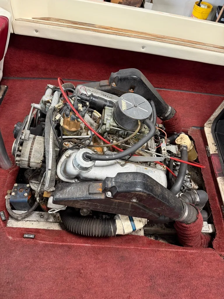 Slide: The Image of An engine in a boat with red carpeting. The engine is exposed, showing various components. - 15