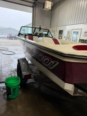 Slide: The Image of A 1987 Correct Craft Ski Nautique 2001 in a garage. The boat features red and white accents. - 18