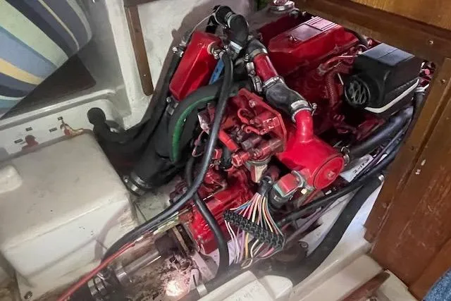 Slide: The Image of Engine compartment of a 1995 Catalina 320 sailboat, featuring a red marine engine. - 31