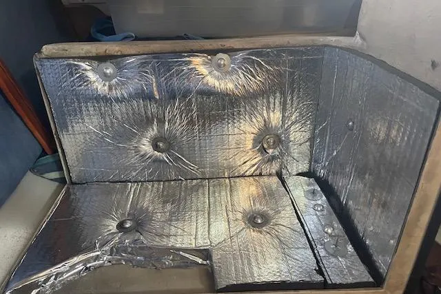 Slide: The Image of Interior of a 1995 Catalina 320 sailboat with metallic insulation panels. - 32