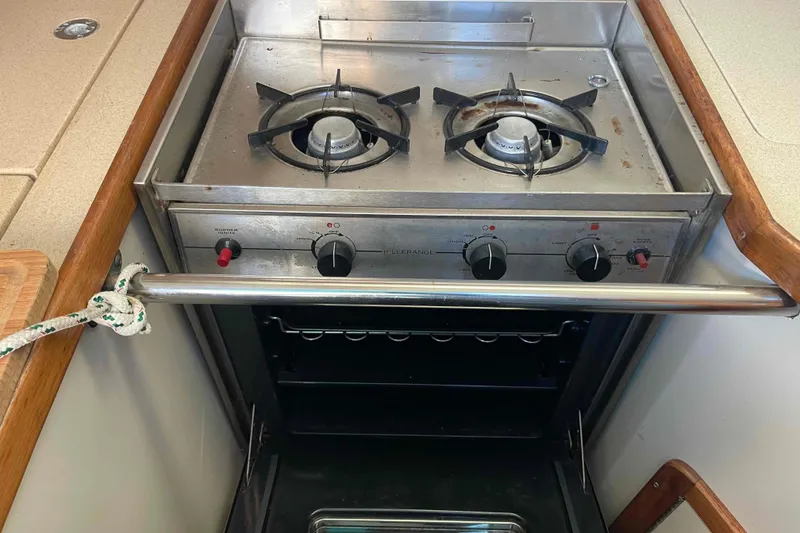 Slide: The Image of Catalina 320 yacht kitchen with a Hillerage two-burner stove and oven. - 23