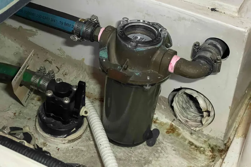 Slide: The Image of Bilge area of a 1995 Catalina 320 sailboat with plumbing components. - 35