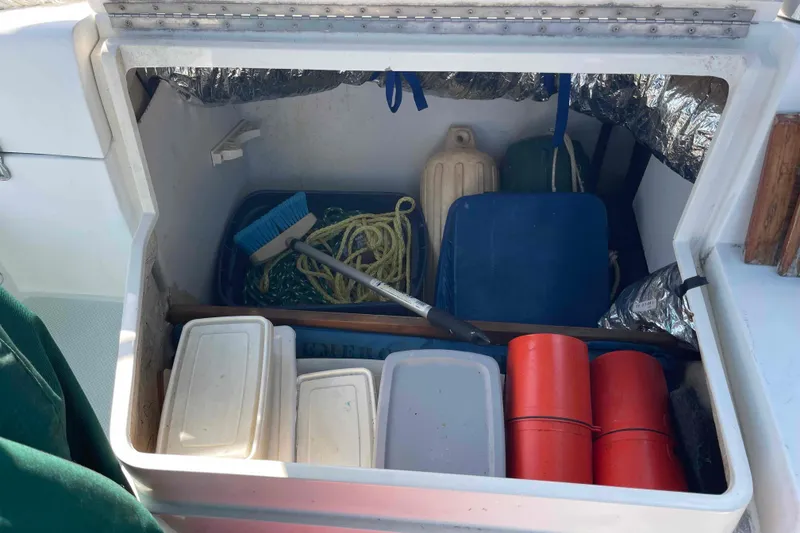 Slide: The Image of Storage compartment on a Catalina 320 sailboat with cleaning supplies and equipment. - 84