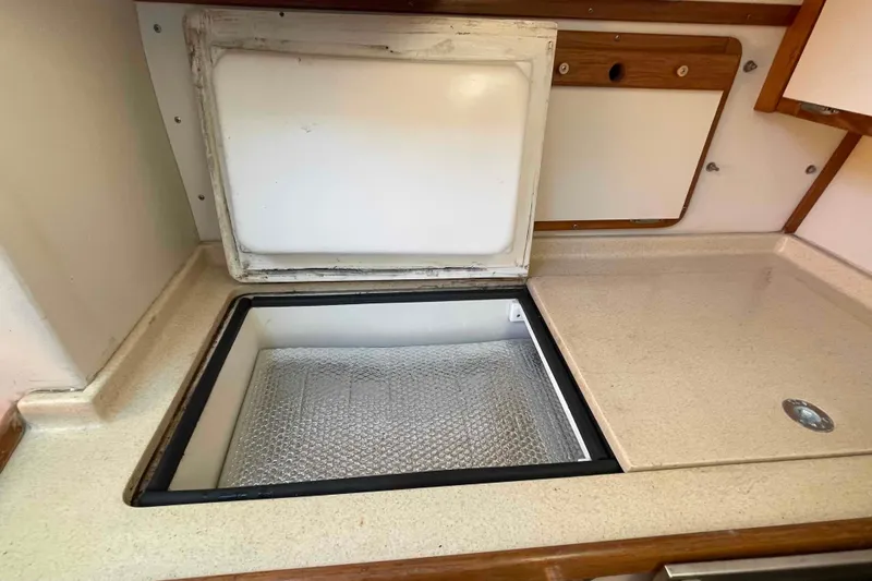 Slide: The Image of Open storage compartment in 1995 Catalina 320 boat kitchen area. - 18