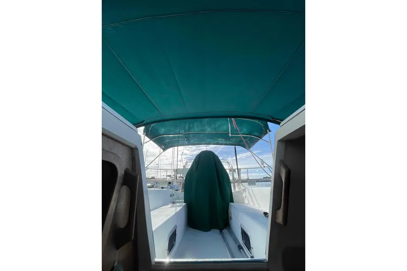 Slide: The Image of Catalina 320 sailboat cockpit with green canopy and covered helm. - 64