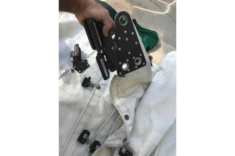 Slide: The Image of Sail hardware for 1995 Catalina 320, featuring rigging components and sailcloth. - 116