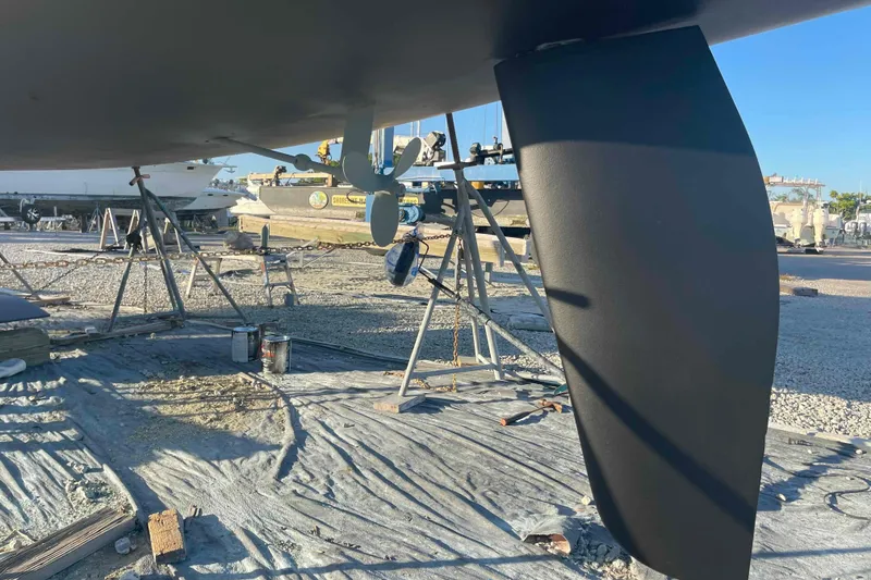 Slide: The Image of Catalina 320 sailboat under maintenance, showcasing keel and propeller in a boatyard. - 43