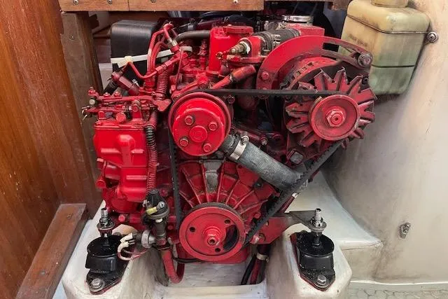 Slide: The Image of Red engine of a 1995 Catalina 320 sailboat, mounted in a compact engine compartment. - 28