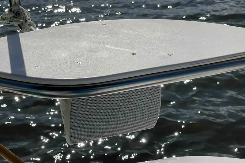 Slide: The Image of Catalina 320 sailboat deck detail with speaker reflecting sunlight on water. - 85