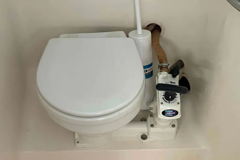 Slide: The Image of Marine toilet in a Catalina 320 sailboat, featuring a Jabsco manual pump. - 13