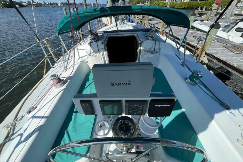 Slide: The Image of Cockpit of Catalina 320 sailboat with Garmin navigation system and teal canopy. - 77