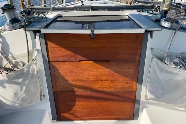 Slide: The Image of Wooden hatch of a 1995 Catalina 320 sailboat, with ropes and winches visible. - 80