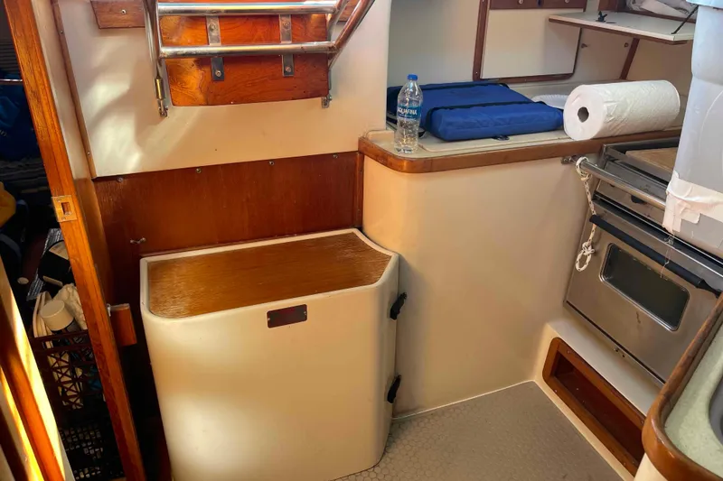 Slide: The Image of Interior of a Catalina 320 sailboat galley with stove, storage, and countertop. - 26