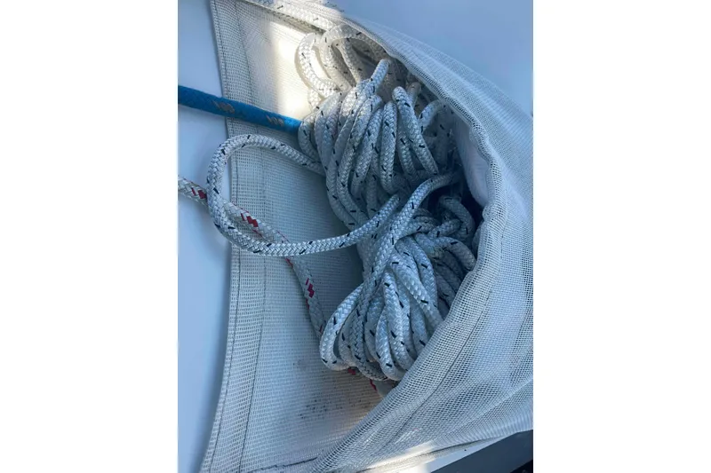 Slide: The Image of Coiled rope in mesh bag on 1995 Catalina 320 sailboat deck. - 112