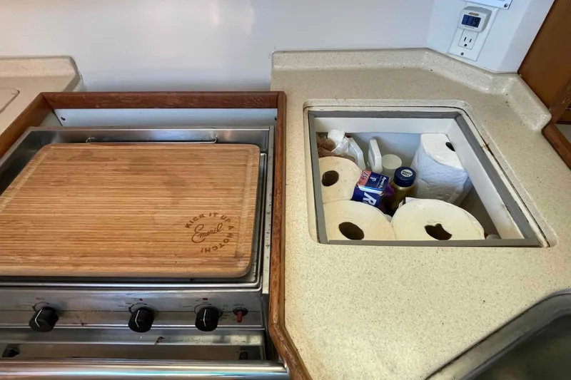 Slide: The Image of Galley kitchen in Catalina 320 yacht with cutting board and storage compartment. - 24