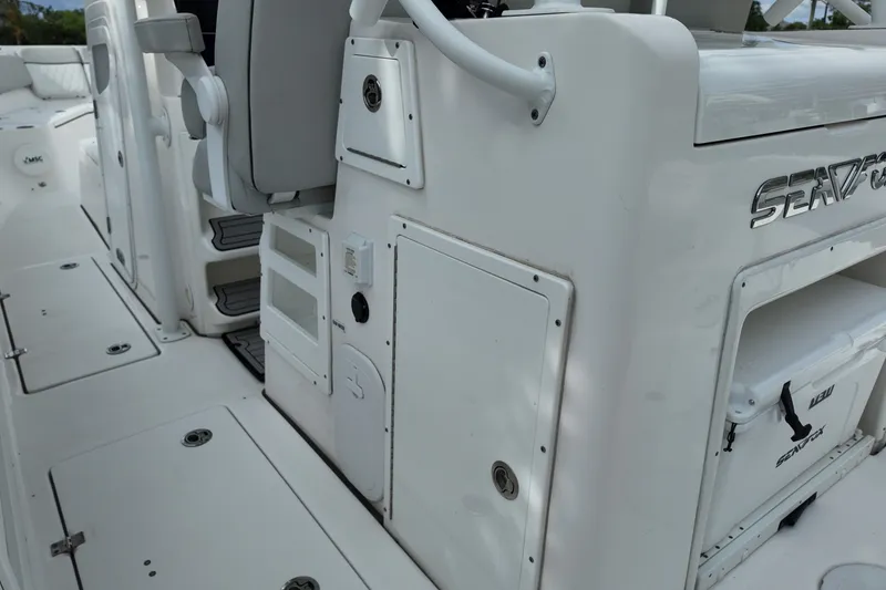 Slide: The Image of 2023 Sea Fox 328 Commander boat interior with storage compartments and seating. - 16
