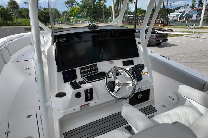 Slide: The Image of 2023 Sea Fox 328 Commander boat dashboard with steering wheel and modern controls. - 5