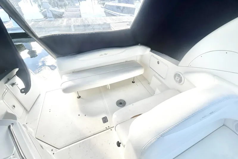 Slide: The Image of 2006 Sea Ray Sundancer 280 interior with white seating and dock view. - 15