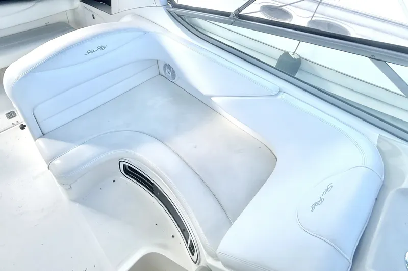 Slide: The Image of 2006 Sea Ray Sundancer 280 boat interior with white cushioned seating. - 13